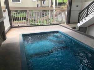 a swimming pool in the middle of a house at Orak Villa @ Kayangan Heights in Shah Alam