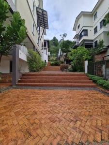a brick walkway in front of some buildings at Orak Villa @ Kayangan Heights in Shah Alam