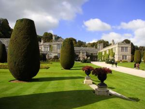 a garden with trees in front of a building at 3 bed in Fowey 53664 in Warleggan