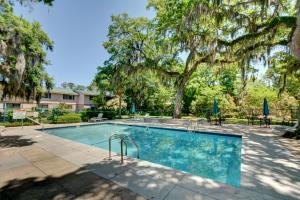 a swimming pool in a yard with trees at Turtle Cove in Saint Simons Island