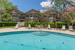 a swimming pool in front of a house at Harbour Oaks 606 in Saint Simons Island