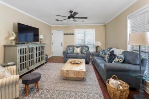 una sala de estar con un sofá y una mesa en Slack Tide Cottage, en Saint Simons Island