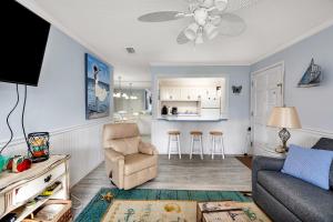 a living room with a couch and a chair at Ocean Walk H-14 in Saint Simons Island