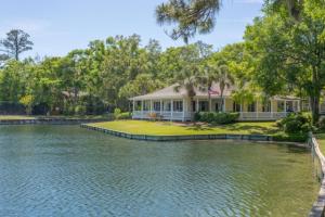 a house with a pond in front of it at Ocean Walk H-14 in Saint Simons Island