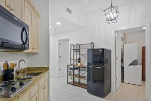 a kitchen with a stainless steel refrigerator in it at Salt Therapy in Saint Simons Island