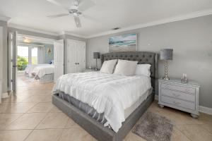a bedroom with a large bed with a ceiling fan at Birds Eye View in Saint Simons Island