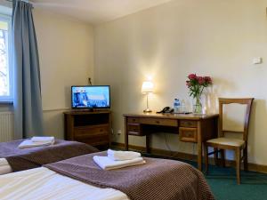 Postel nebo postele na pokoji v ubytování Hotel Łazienkowski
