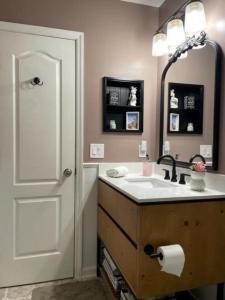 a bathroom with a sink and a mirror at The Squeezebox in Saint Simons Island