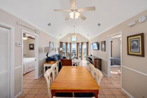 a dining room with a table and a bedroom at Sea Spray in Saint Simons