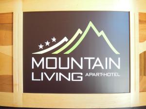 a sign for mountain living on a wall at Mountain Living Apartments in San Valentino alla Muta