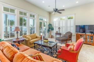 a living room with a couch and chairs and a tv at Beachview 911 in Saint Simons