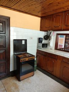 a kitchen with a stove top oven in a kitchen at Zack's Serene House in Kisii