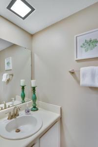 a white bathroom with a sink and a mirror at Courtyard Villa C-4 Butterfly Villa in Saint Simons Island