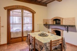 a dining room with a table and a fireplace at Agriturismo Fadanelli - Il Forno in Lamporecchio