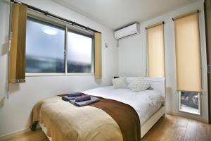 a bedroom with a bed with a large window at kameido k hotel in Tokyo