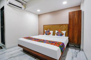 ein Schlafzimmer mit einem großen Bett in einem Zimmer in der Unterkunft FabHotel New 7 Star in Mumbai
