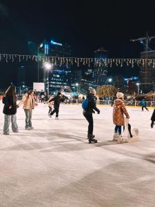 a group of people skateboarding in a rink at night at Caro Hotel in Bucharest