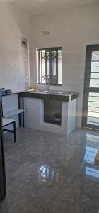 a kitchen with a counter and a sink in a room at Salama Apartments in Lusaka
