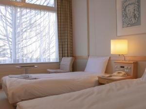 Postel nebo postele na pokoji v ubytování Shigakogen Prince Hotel + 37 fotografií