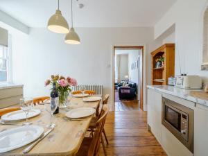 a kitchen and dining room with a wooden table and chairs at 3 Bed in Crosthwaite 75564 in Crosthwaite