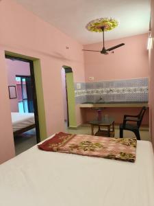 a bedroom with a bed and a table and a table at Liya guest house in Tiruvannāmalai