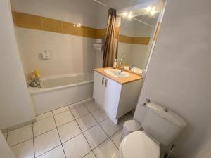 a bathroom with a toilet and a sink and a tub at Studio Cité médiévale 250 m in Carcassonne +12 photos