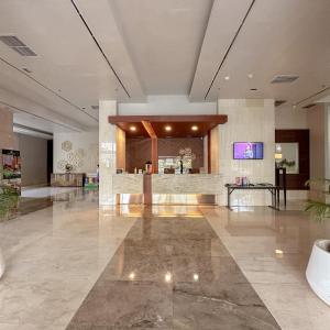 a lobby with a reception desk in a building at Senayan Jakarta Oasis - Gym, Pool, Netflix in Jakarta +24 photos