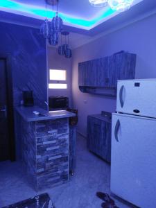 a kitchen with a white refrigerator in a room at Hurghada City Apartment2 in Hurghada