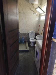 a small bathroom with a toilet and a sink at Hurghada City Apartment2 in Hurghada