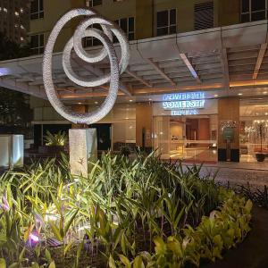 a sculpture of the olympic symbol in front of a building at Senayan Jakarta Oasis - Gym, Pool, Netflix in Jakarta