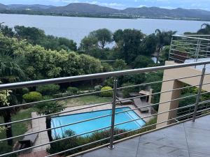 a balcony with a view of the water at Cozy Coleman in Hartbeespoort