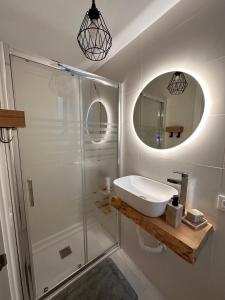 a white bathroom with a sink and a shower at Papá Totë Deluxe in Playa Honda +70 photos
