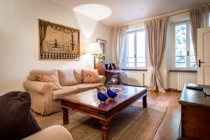 a living room with a couch and a coffee table at Lake Charming Apartment in Cernobbio