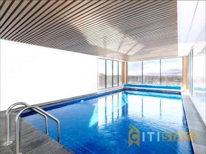 a swimming pool with blue water in a building at Delight in Dickson -2bd 2bth 2Csp Apt in Canberra