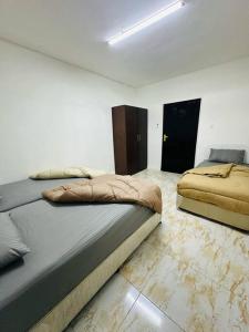 a bedroom with two beds in a room at Private Entrance 2 Bedroom Apartment fully furnished in Abu Dhabi