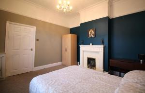a bedroom with a bed and a fireplace at Large 3 Bed Bungalow - Beautiful Refurb - Garden in Birmingham