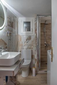 a bathroom with a sink and a toilet and a shower at Alkea Thessaloniki in Thessaloniki