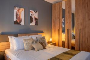 a bedroom with a bed and some paintings on the wall at Alkea Thessaloniki in Thessaloniki