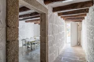 a room with a stone wall and a wooden floor at Casa Carolina in Porto