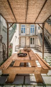un patio con una mesa de madera y un edificio en Casa Carolina, en Oporto