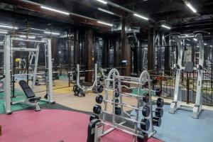 a gym with a lot of equipment in it at Jannat Regency in Bishkek