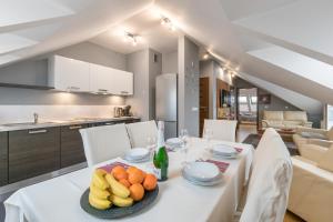 a dining room with a white table with fruit on it at Apartamenty Smile in Zakopane