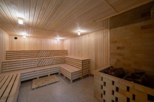 a sauna with a wooden bench in a room at Jannat Regency in Bishkek