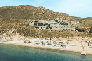 an aerial view of a beach with chairs and umbrellas at Coco-Mat Eco Residences Serifos in Vayiá
