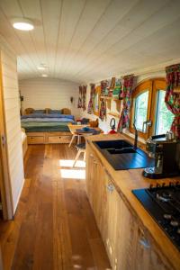 a kitchen and living room of a tiny house at La Tiny House de la Bergerie in Lierneux