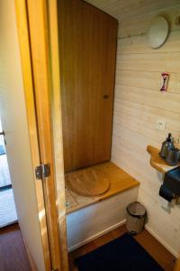 a small room with a wooden cabinet on the wall at La Tiny House de la Bergerie in Lierneux