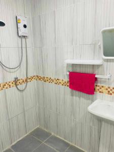 a bathroom with a shower and a red towel at Kohmook Happy time Bungalow in Koh Mook
