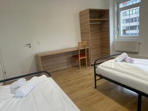 a hospital room with two beds and a chair at Timeless: 4 Zimmer Apartment Ludwigsburg in Ludwigsburg