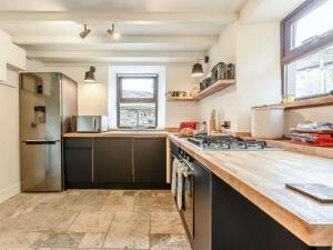 a kitchen with a counter top and a refrigerator at 4 Bed in Hawes 89363 in Hawes