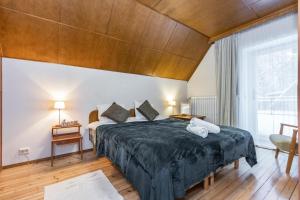 a bedroom with a large bed with a wooden ceiling at Gustav Ernesaks- Kadriorg in Tallinn